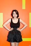 Skinny Chinese babe Li Zheng poses in the black T-shirt and skirt